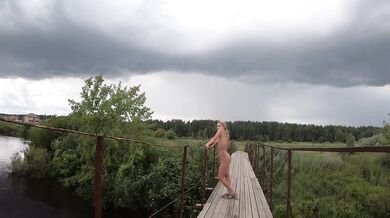 Naked Russian teen walks public bridge flashing tattoos